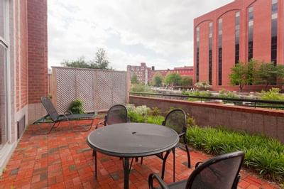Closeup of outdoor lounge area by the pond at UMass Lowell Inn