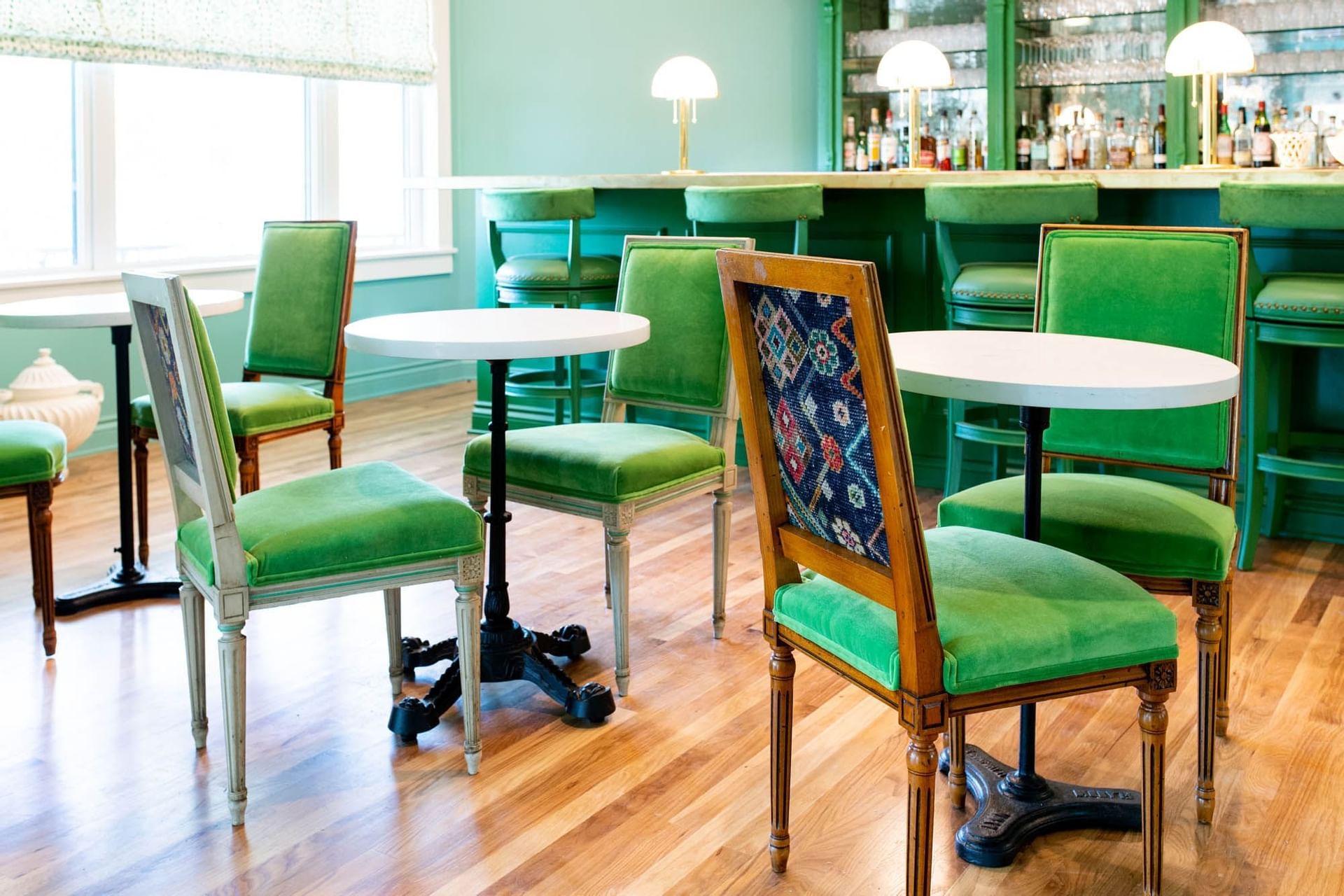 green chairs at bar in blue room