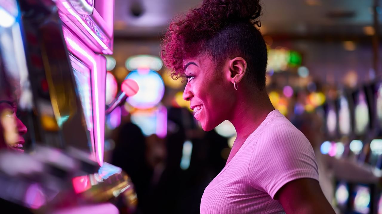 Woman playing slot machine at a casino