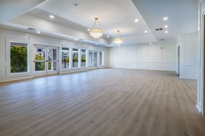 Spacious event room with polished wooden floors at Grant Street Inn in Dunedin FL