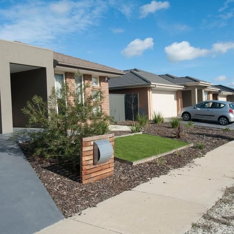 Modern houses with car parked and well-maintained garden at La Trobe University Regional Housing Shepparton.