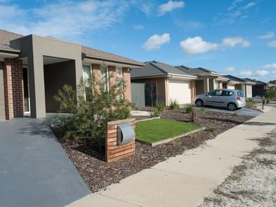 Modern houses with car parked and well-maintained garden at La Trobe University Regional Housing Shepparton.