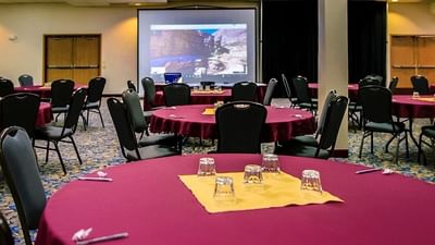 Spacious conference room at Moab Valley Inn with a banquet table set up and a large projector screen