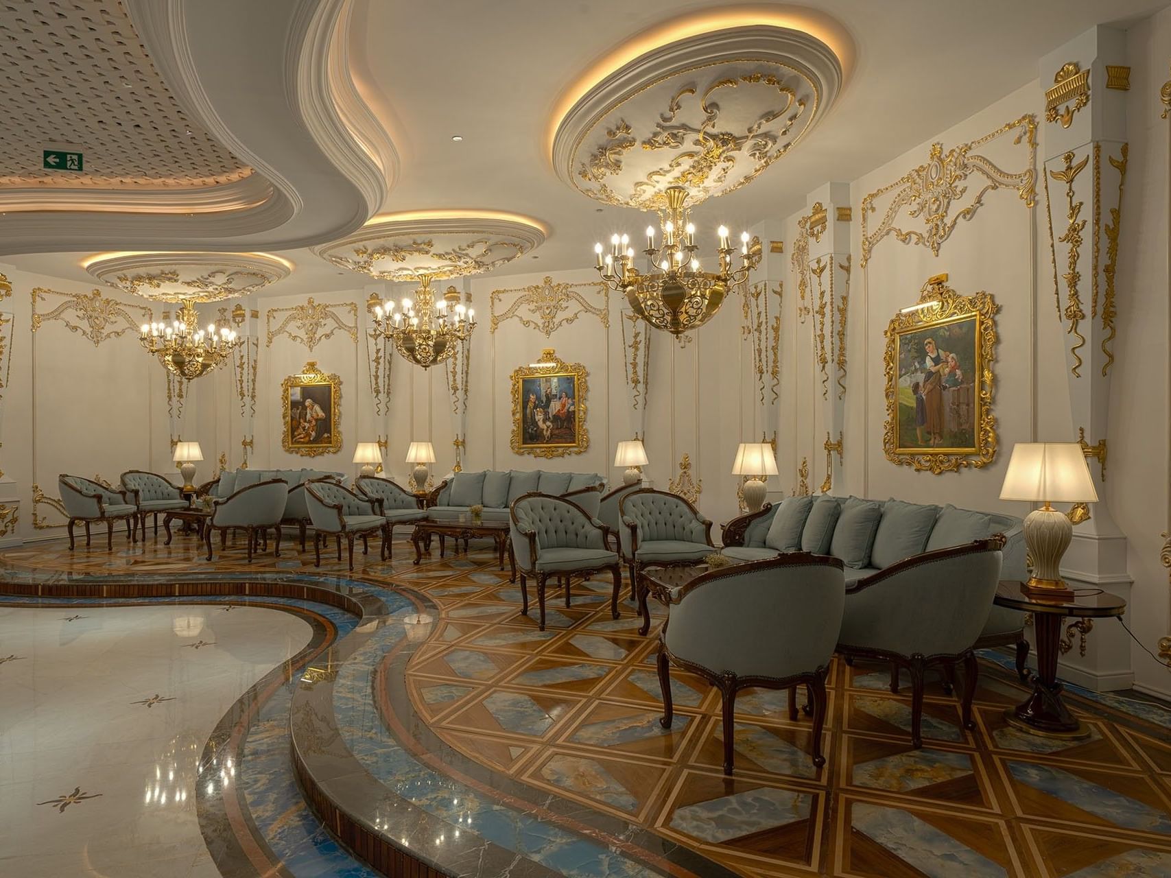 Lavishly decorated lounge area with chandeliers and gold accents at World Heart Hotel Baghdad.