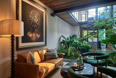 Cozy living area with a sofa, and an indoor courtyard with a spiral staircase in Casa Cielo at Singular Signature Residences