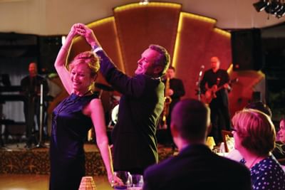 Couple dancing while band plays.