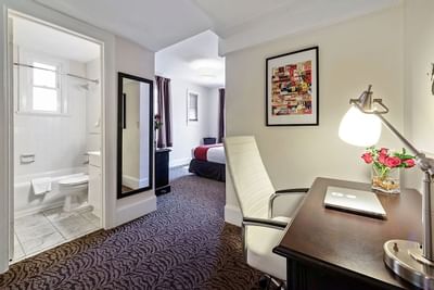 A desk area in a guest room at Artmore Hotel
