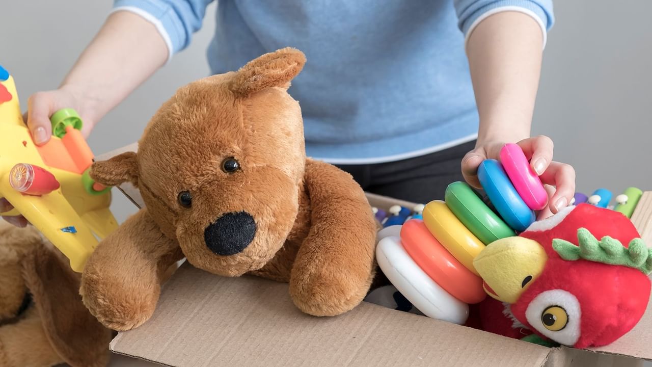 kid toys with a stuffed bear