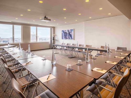 Meet 26 Three Meeting room with tables arranged in a U-shape, and chairs at The Hotel Brussels