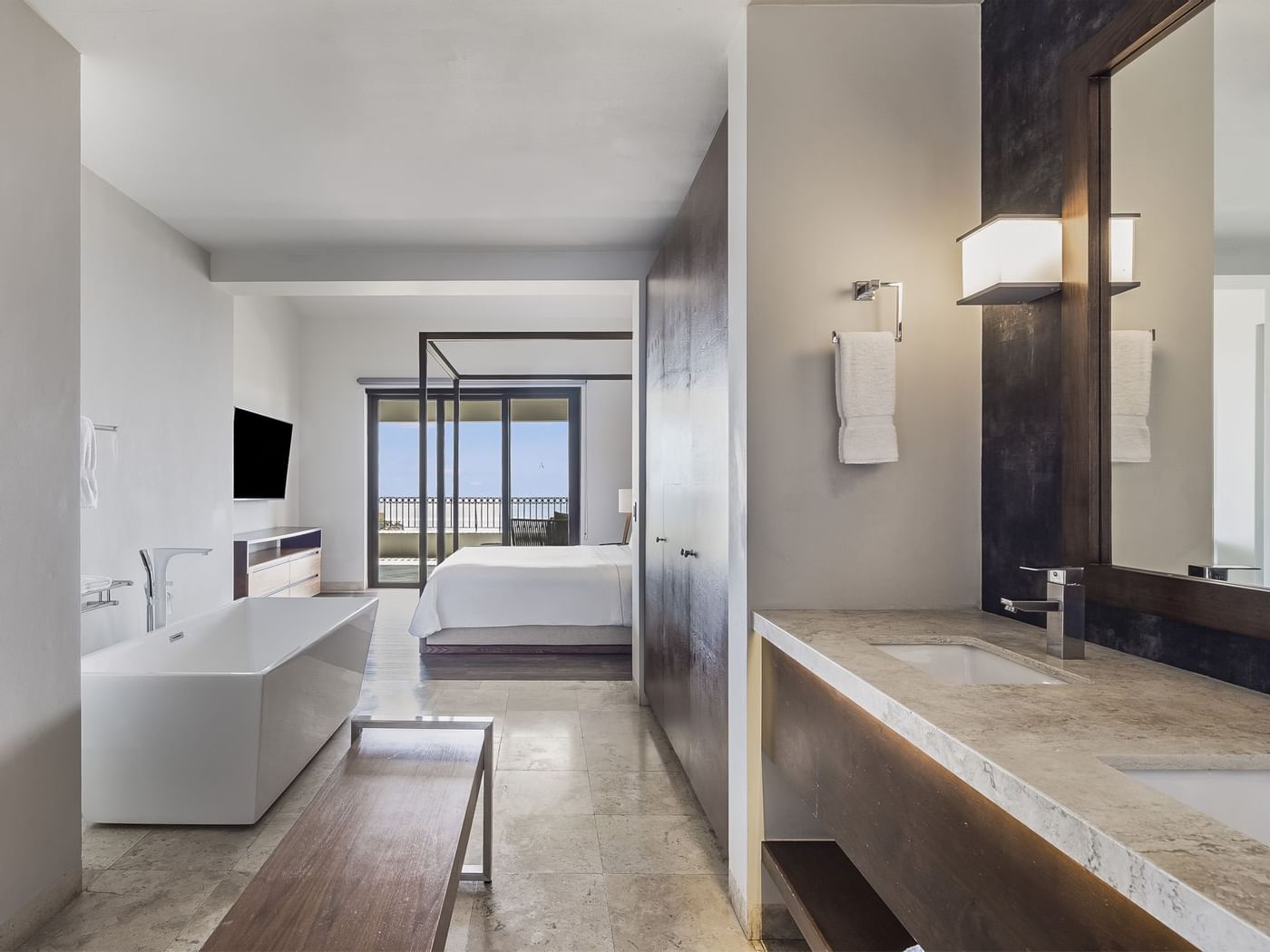 Bathroom vanity with bathtub and bed in Four Bedroom Residence at Live Aqua Resorts