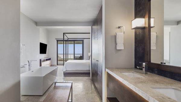 Bathroom vanity with bathtub and bed in Four Bedroom Residence at Live Aqua Resorts