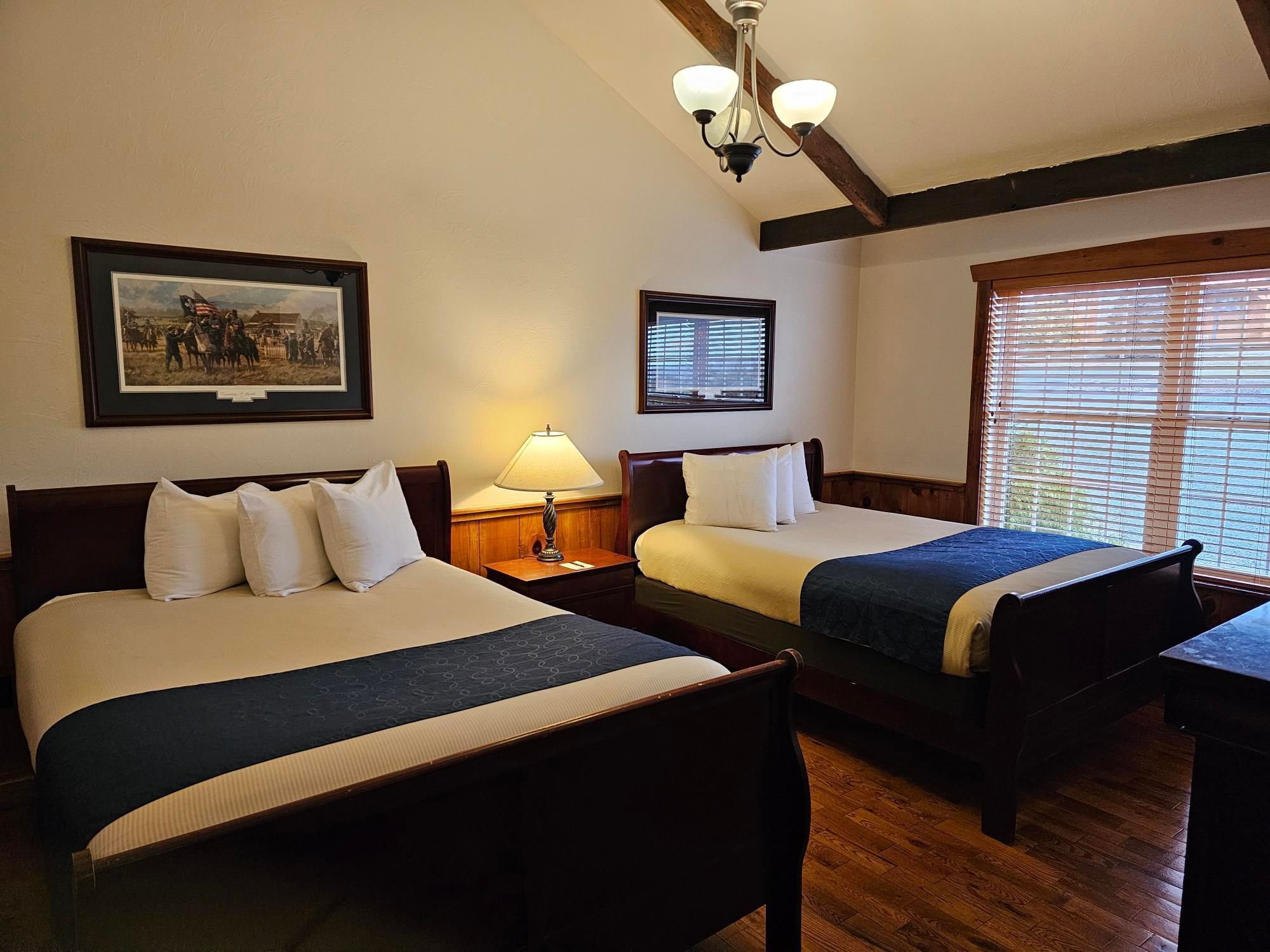 Lieutenant's Lodge with two beds with pillows, and a nightstand at The Lodges at Gettysburg hotel in PA.