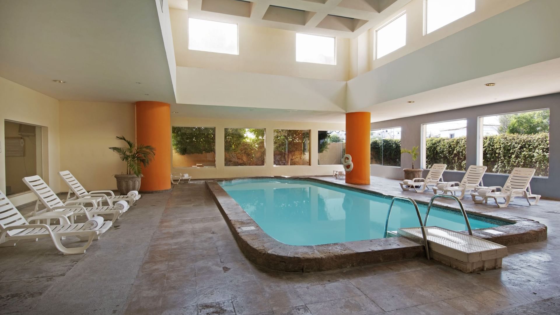 Indoor pool with sunbeds at Fiesta Inn Hermosillo