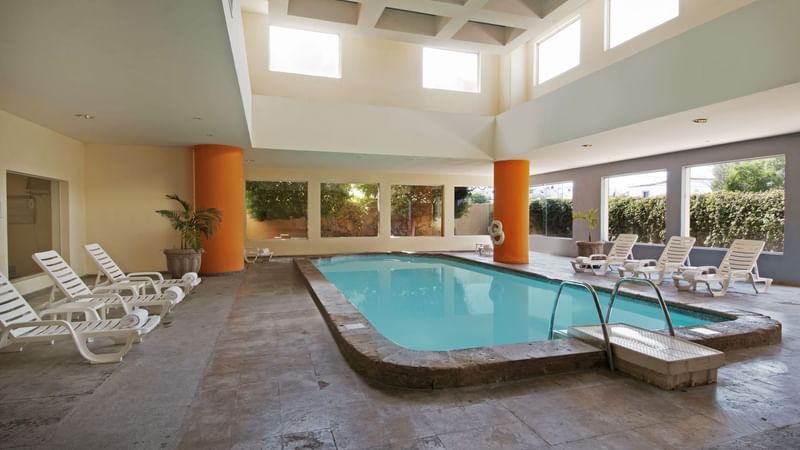 Indoor pool with sunbeds at Fiesta Inn Hermosillo