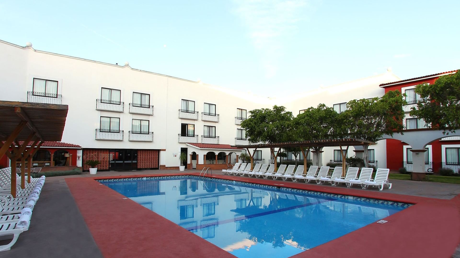 Sunbeds by the outdoor pool at Fiesta Inn Querétaro