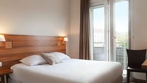 Interior of a bedroom at Hotel Colmar Train Station