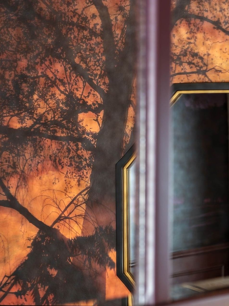 Tree mural on wall with mirror reflection in an Executive Room at The Capital Hotel, Apartments & Townhouse