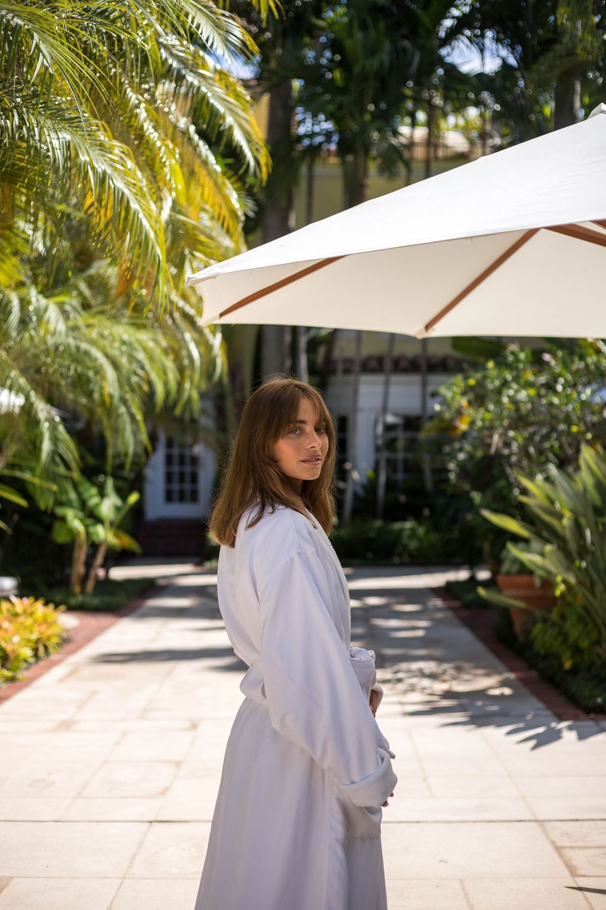 A girl standing under an umbrella at Brazilian Court
