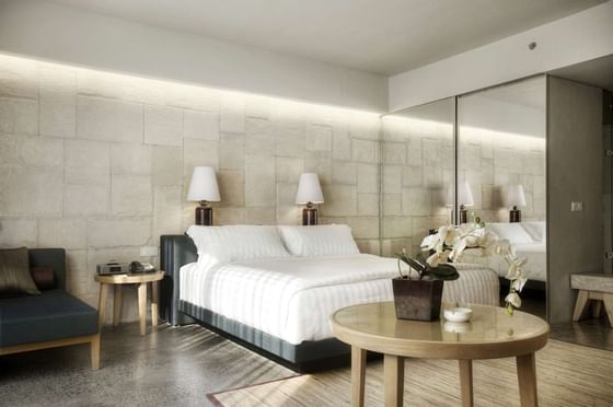 Elegant room with comfy white bed at U Hotels