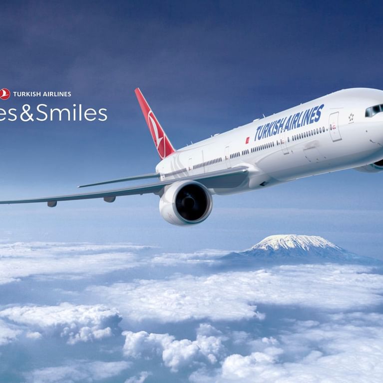 Turkish Airlines jet flying above clouds at Titanic Hotels