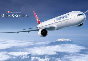 Turkish Airlines jet flying above clouds at Titanic Hotels