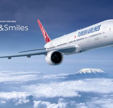 Turkish Airlines jet flying above clouds at Titanic Hotels