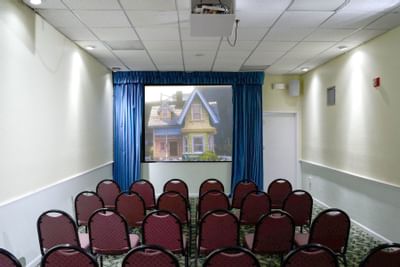 Small theatre showing a movie with a colorful house