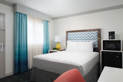 a bed and chair in a hotel room