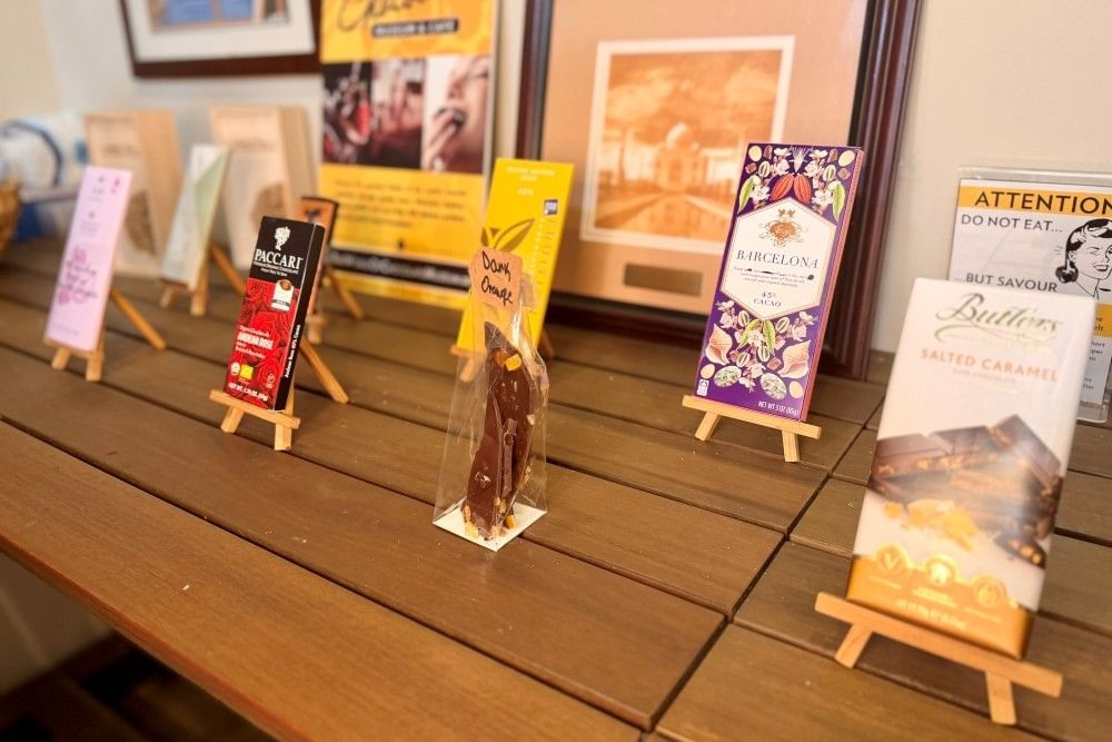 A variety of colorful chocolate bars sitting on easels on display at the Chocolate Museum and Cafe in Orlando.