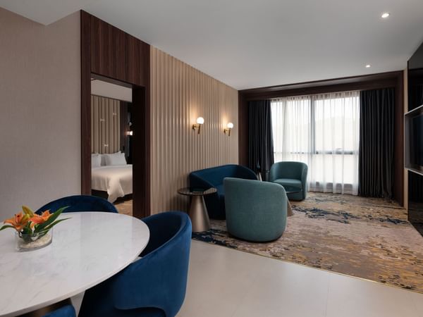 Interior of the living area with dining table and armchairs at Warwick Hotel Al Taif