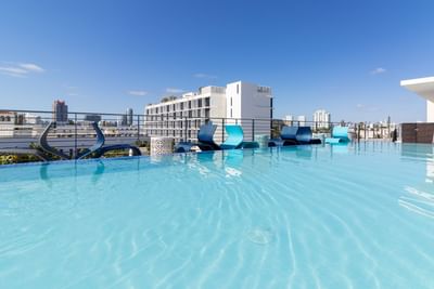 Rooftop Pool with sun loungers overlooking the city at Fairwind Hotel Miami