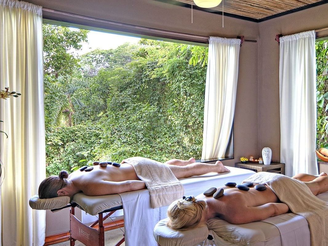 Couple having hot stone treatment in Orquidea Spa & Wellness at Los Altos Resort