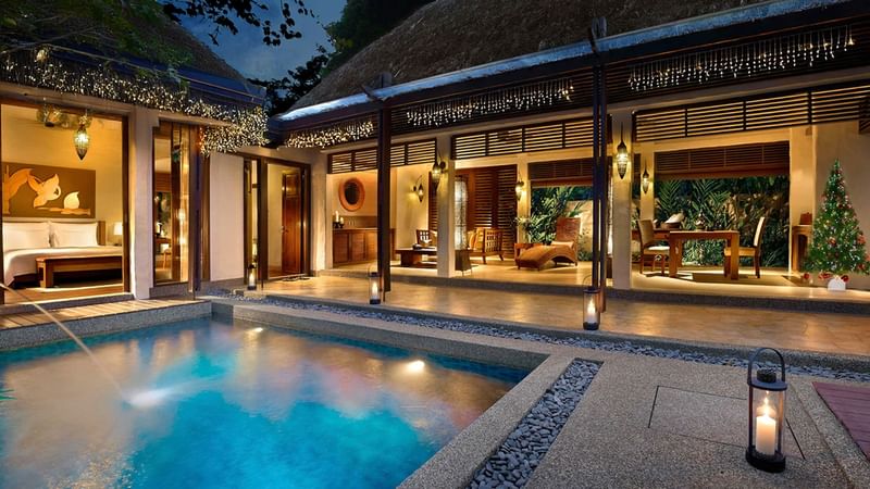 Garden villa with a pool, lit lanterns, and a decorated Christmas tree at night at The Banjaran Festive Season