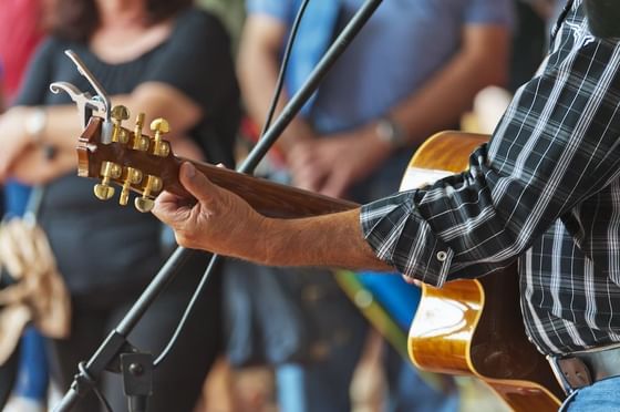 Man playing a guitar in Live Concerts at Stein Eriksen Lodge Deer Valley
