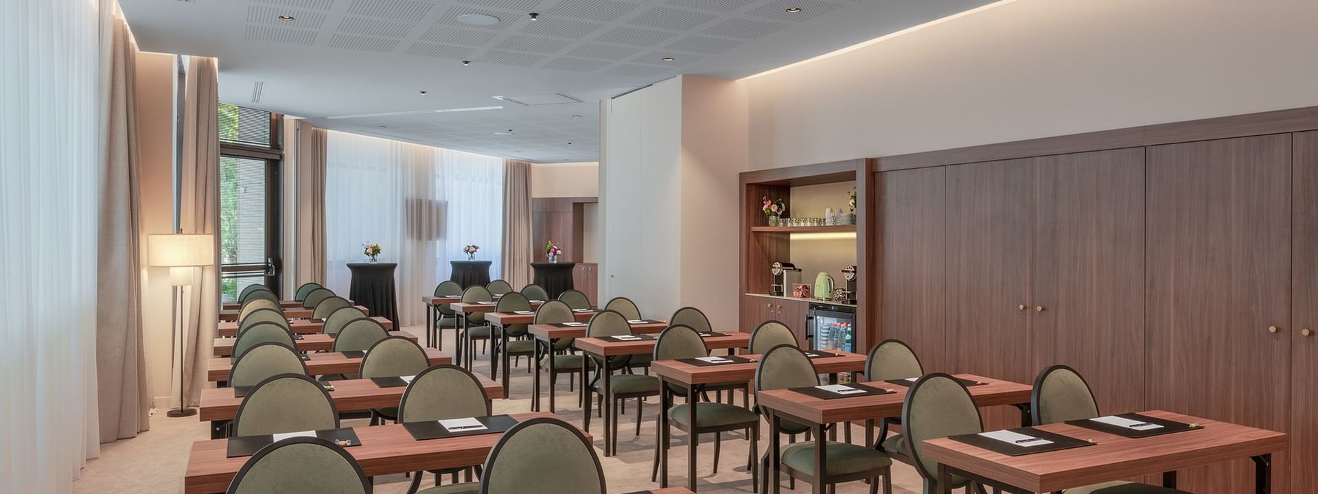 Classroom set-up with wooden shelves and cozy seating in the Astrid Salon at Warwick Reine Astrid - Lyon