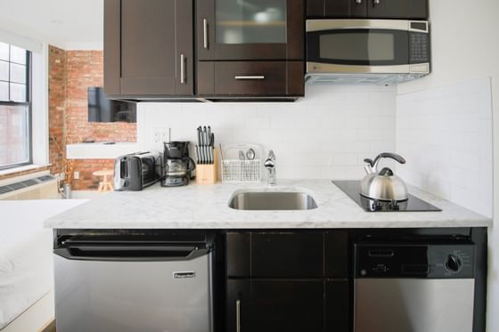 Hotel kitchen with dishwasher and oven.