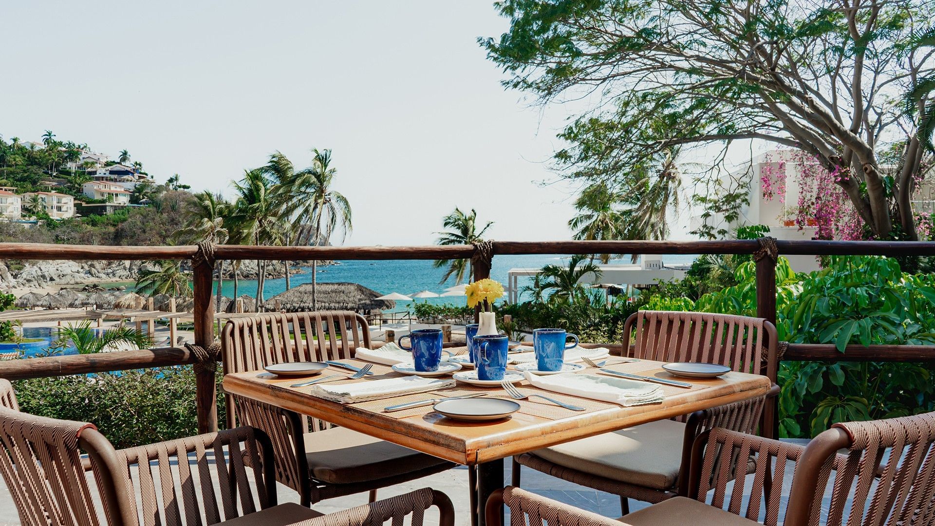 Outdoor terrace dining area with greenery and ocean views in Chez Binni at Camino Real Zaashila Huatulco