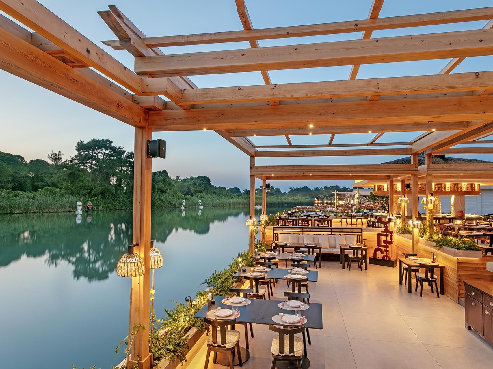 Dining area overlooking the river in Norı Asian Restaurant at Titanic Deluxe Golf Belek