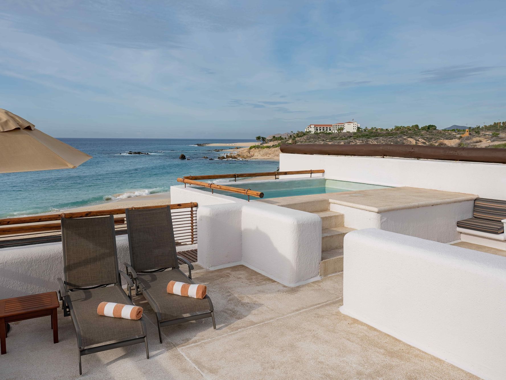 Casita Oceanfront at Marquis Los Cabos Resort featuring a private plunge pool, lounge chairs, and a spacious balcony area