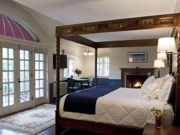 King-size bed in Woodburning Fireplace ​King Room at La Tourelle Hotel and Spa