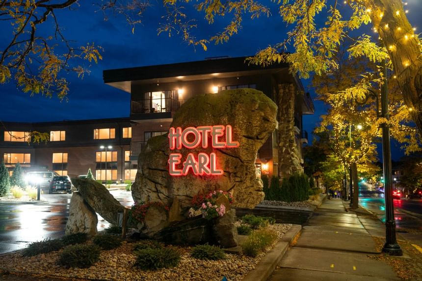 Hotel Earl neon beaver shaped stone sign at night in The Earl
