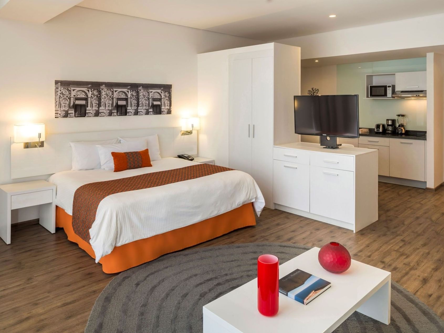 King Junior Suite featuring a kitchenette, living area, and modern white deco at Camino Real Puebla Angelopolis