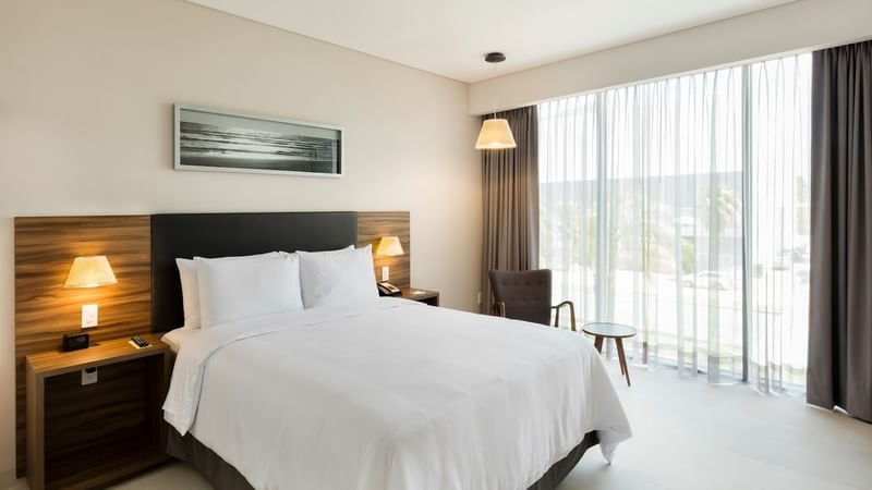 Superior Room at Fiesta Inn Express Cancún Cumbres with a bed & lamps on nightstands, best places to stay in Cancun