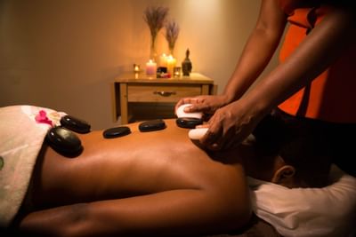 A Hot stone massage experience in a spa at True Blue Bay Hotel