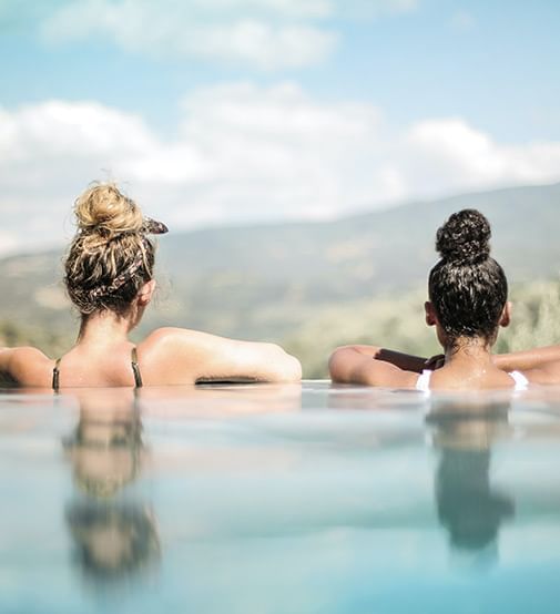 the back of two women in pool