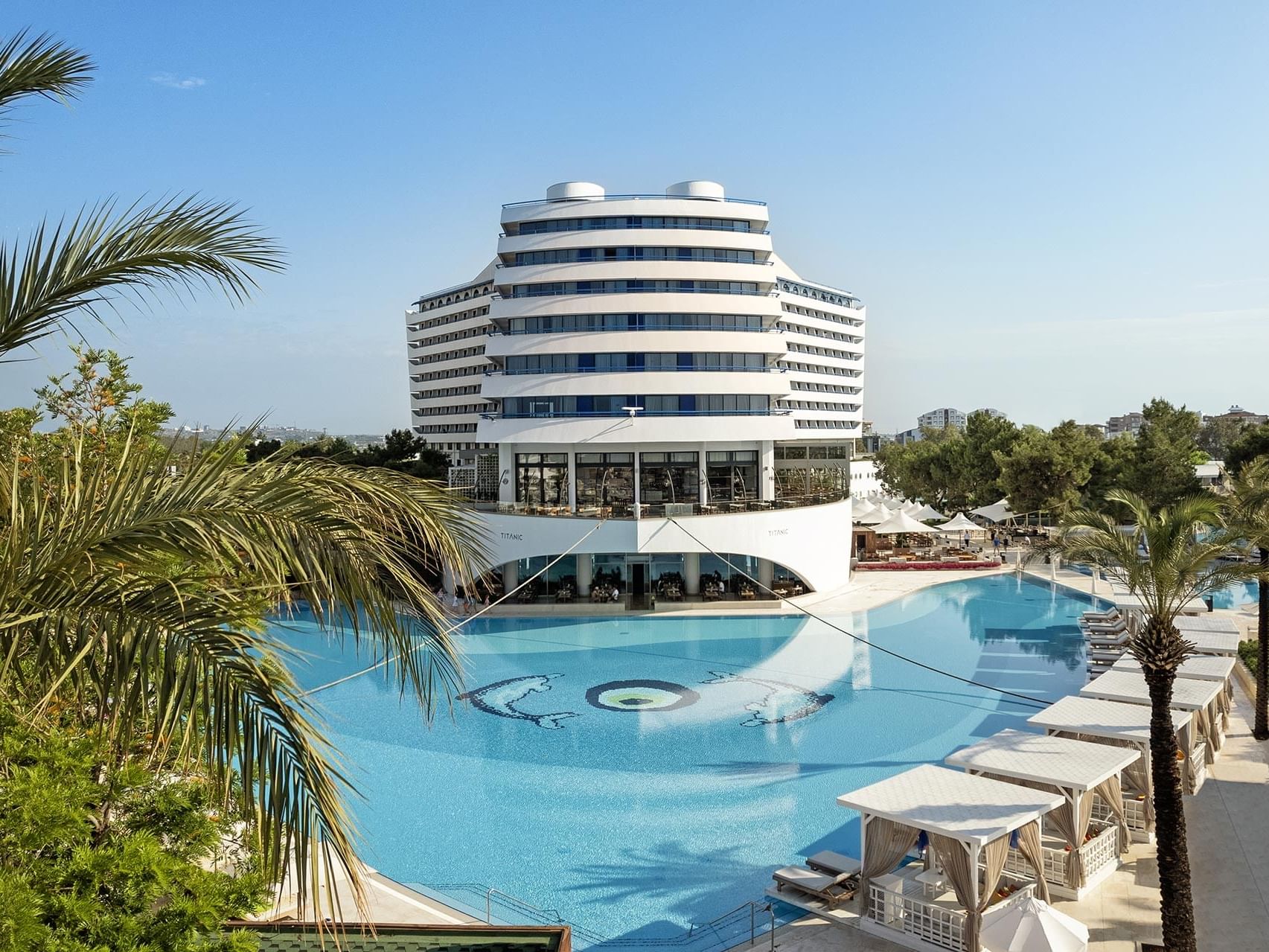 High-angle front view of the Titanic Deluxe Lara building with outdoor pool on a sunny day