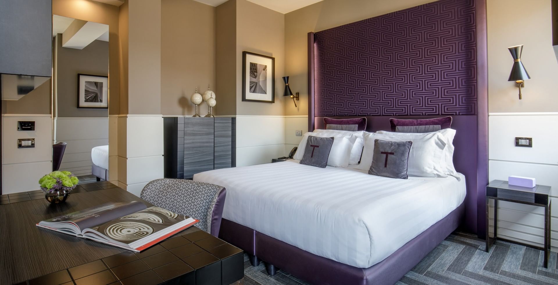 King Bed Room at Tribune Hotel Rome with elegant modern décor, comfortable king bed, work desk, flat-screen TV, and large windows overlooking historic city views.