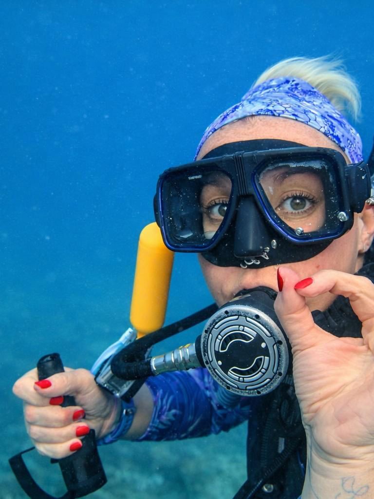Scuba diver underwater making the ok sign at The Naviti Resort dive center in Korolevu.