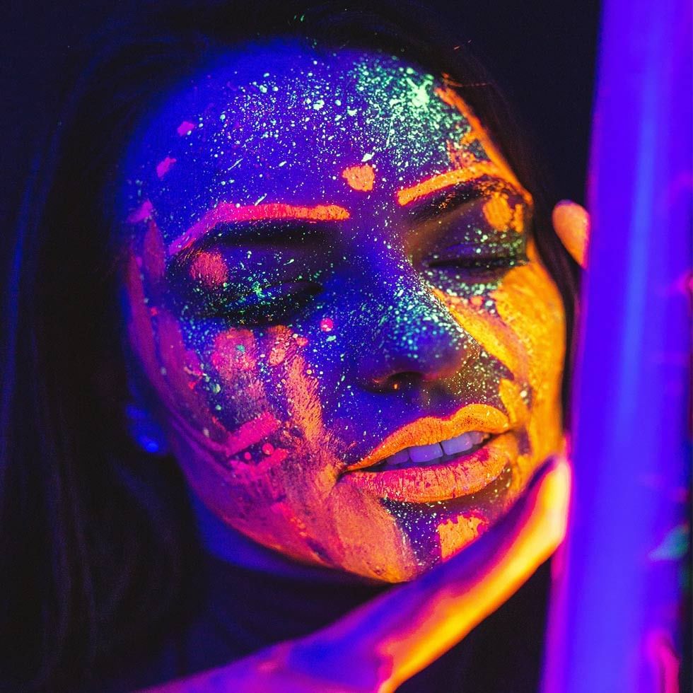 A girl painting radium colors on the face at Falkensteiner Hotel Prague