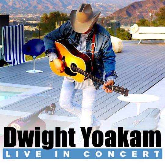 Dwight Yoakam on a patio deck with pool wearing a cowboy hat